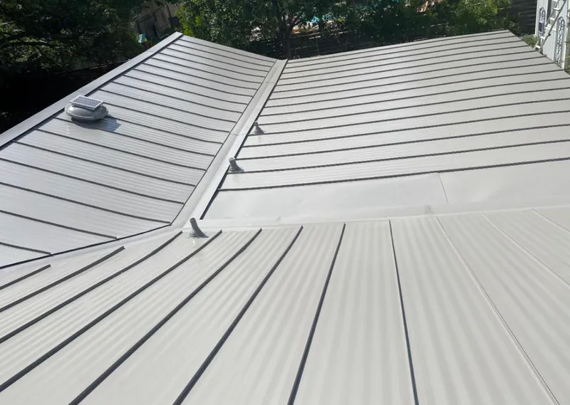 Solar attic fan installed on a metal roof for Roof Ventilation in Crowley